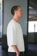 white oversize t-shirt. Sleeves are a little lower an elbow