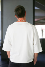 white oversize t-shirt. Sleeves are a little lower an elbow