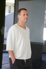 white oversize t-shirt. Sleeves are a little lower an elbow